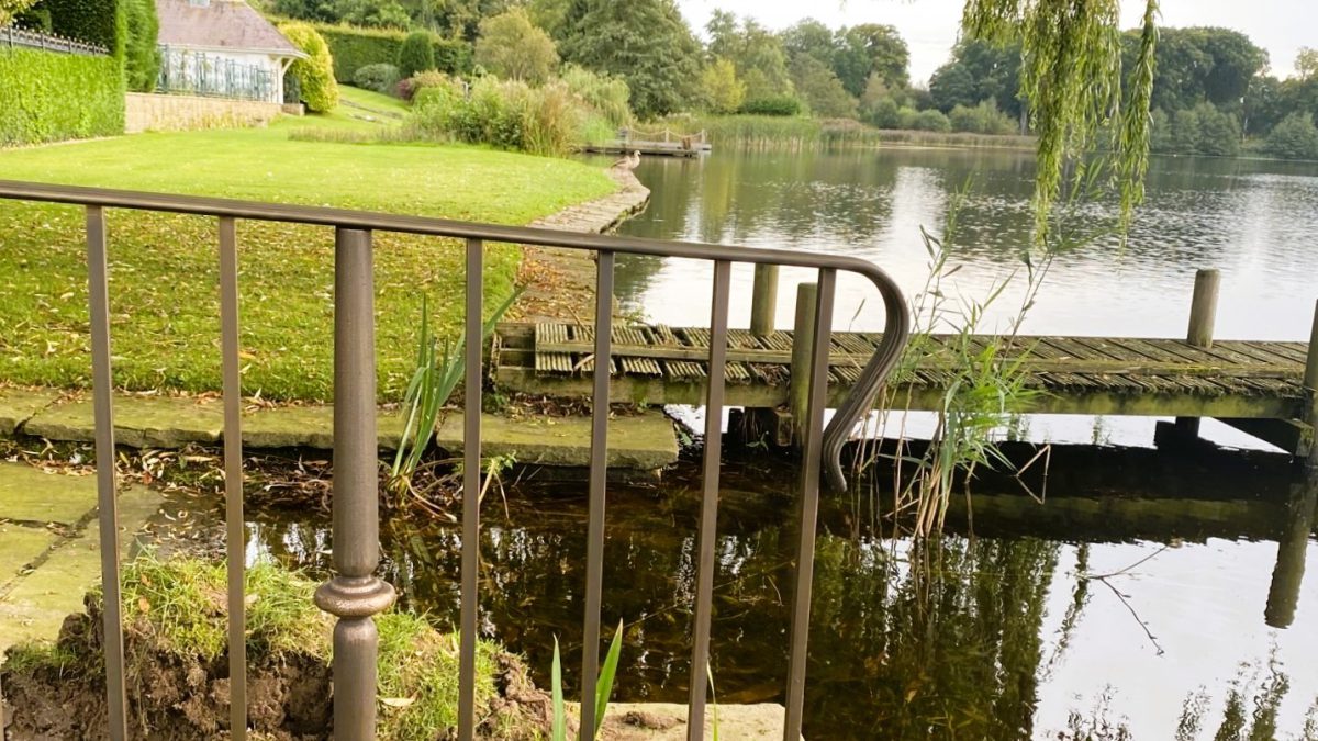 Low level bronze railings to the waterside. Each including a single passenger gate. Work carried out by Calibre Metalwork.