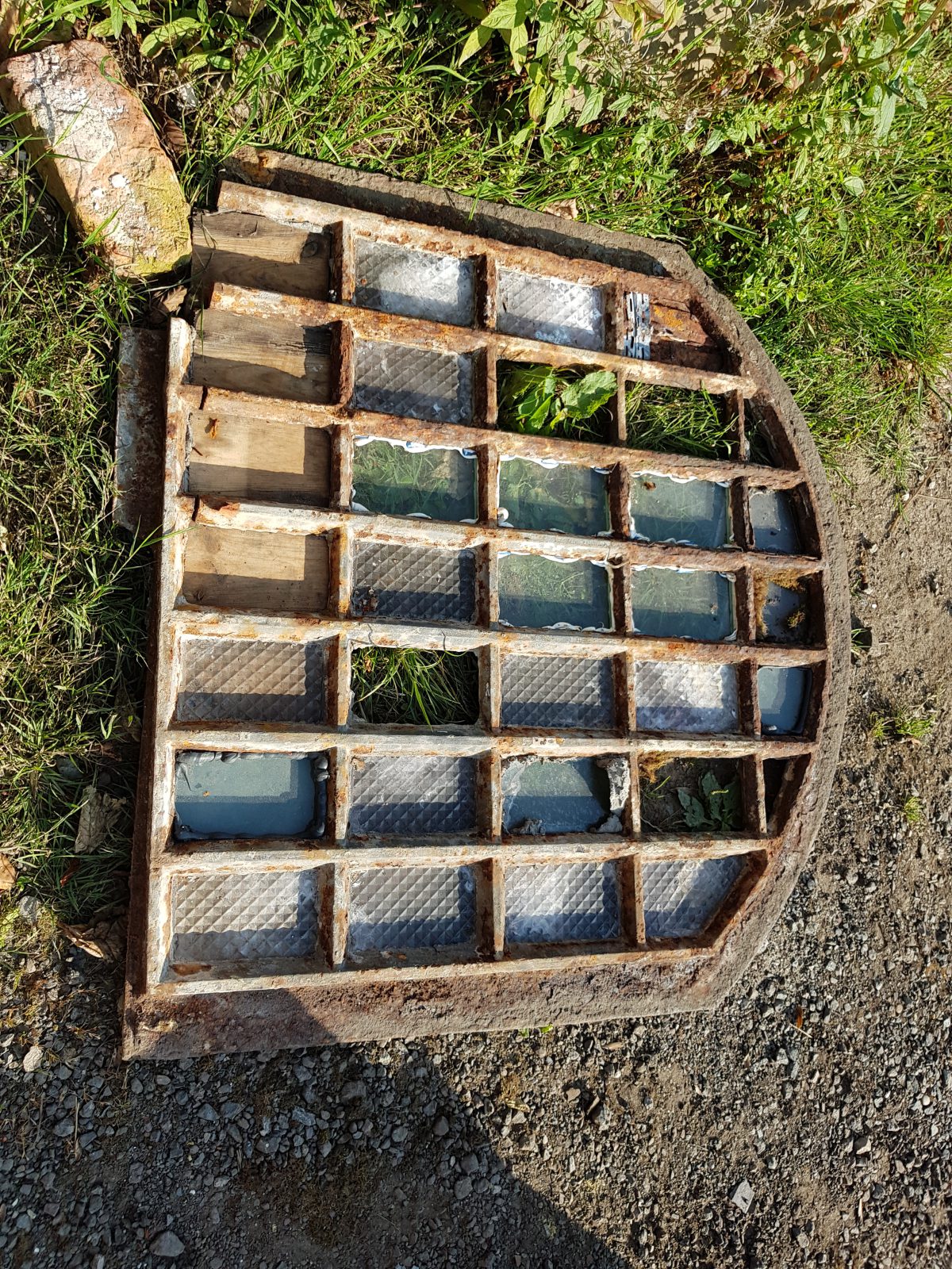A photograph showing the full extent of degradation of the pavement lights from Dale Street, Manchester prior to replication by Calibre Metalwork.
