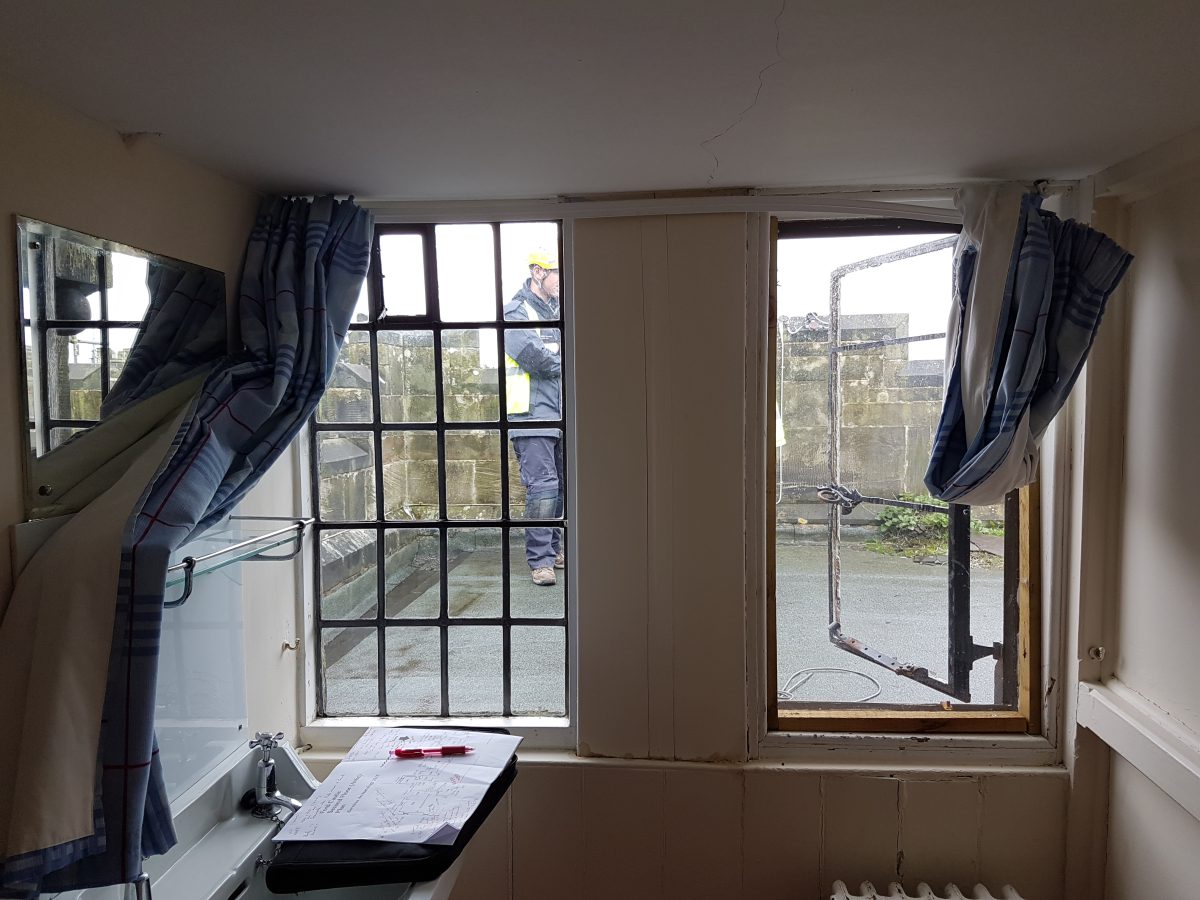 A photograph of the Calibre Metalwork team inspecting the windows at Grade I listed Ford Castle, Berwick-upon-Tweed, Northumberland.