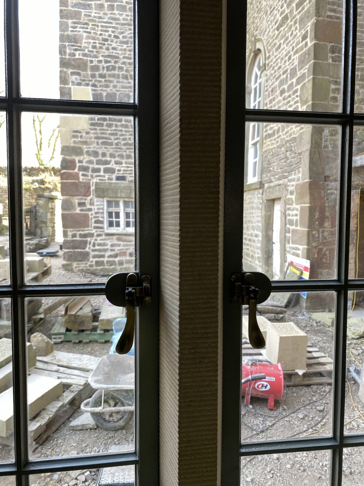 A photograph of dark bronze toned window catches.