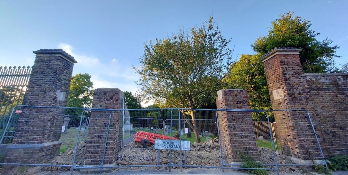 Photograph of brickwork being removed by the main contractor to open up the entrance again.