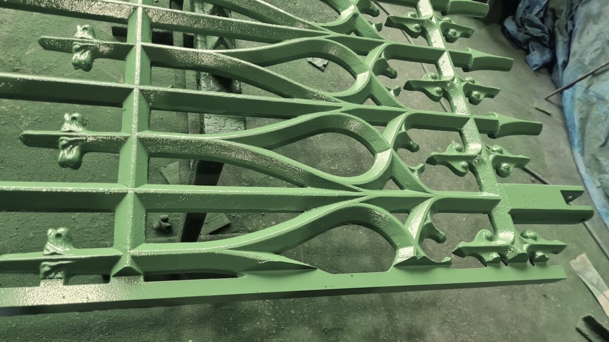 Close up photograph showing the achieved finish on West Norwood cemetery gates. Green is a welcome alternative to the black that is usually specified.